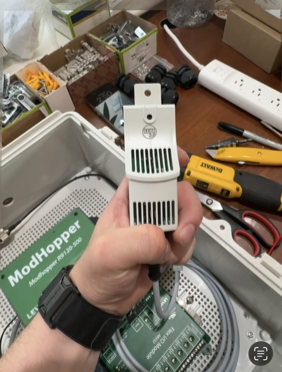 Bench assembly of a site-specific sensor next to ModHopper and Flex I/O components